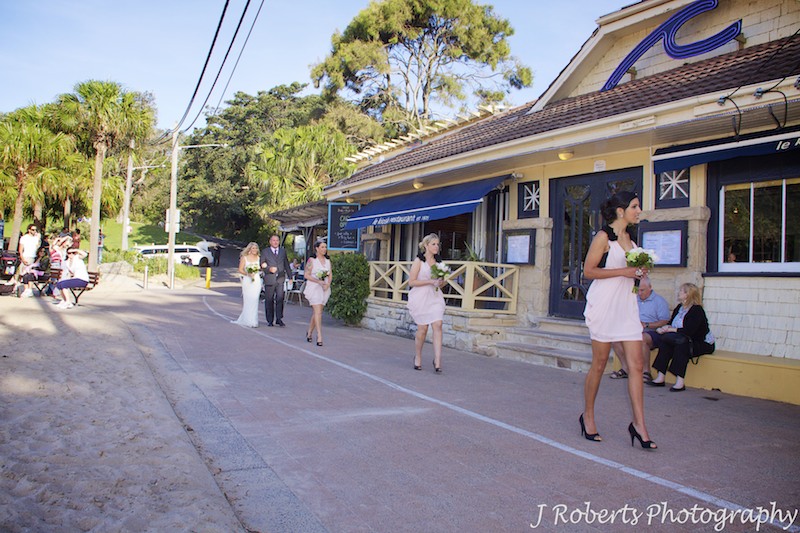Bride walking to wedding ceremony in front of Le Kiosk Shelley Beach - wedding photography sydney